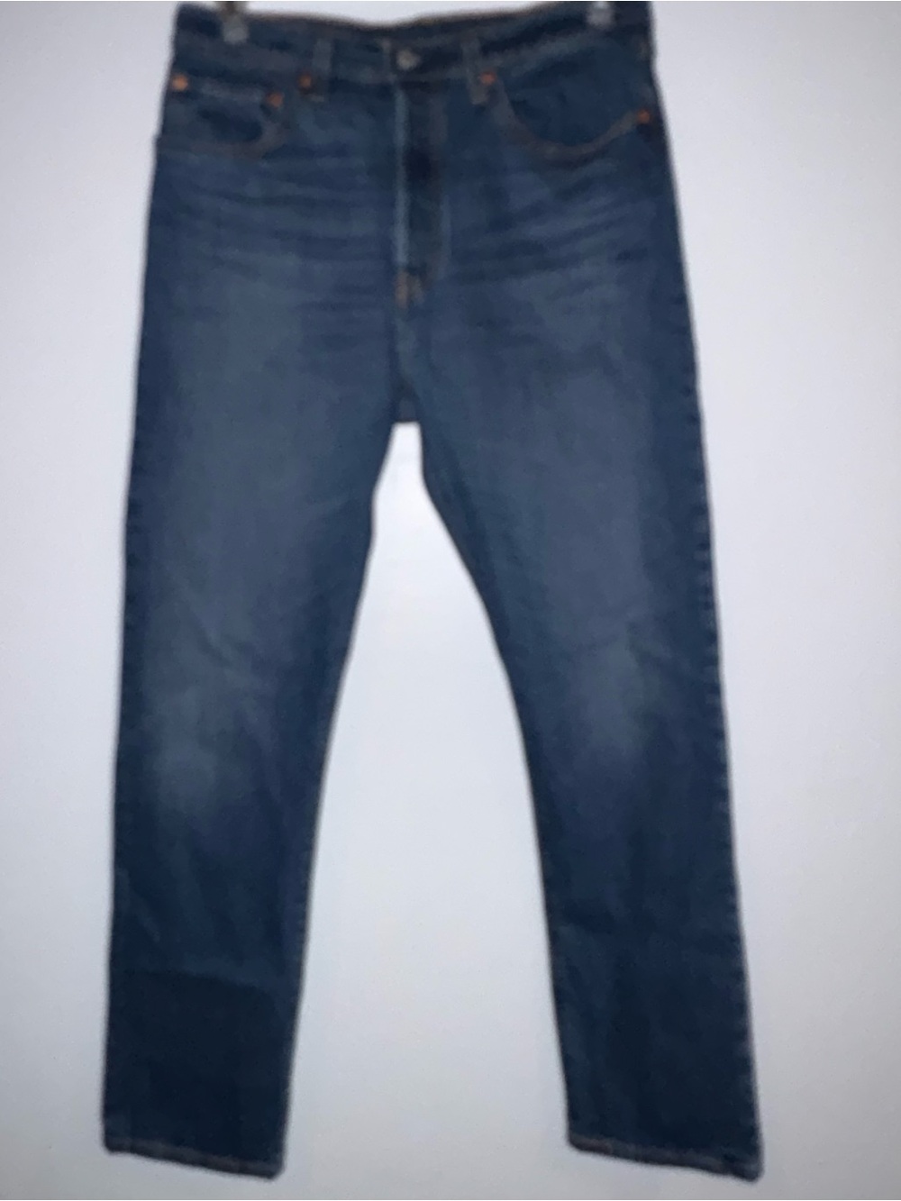 Levi's 501 jeans in a medium blue wash, featuring the iconic button fly